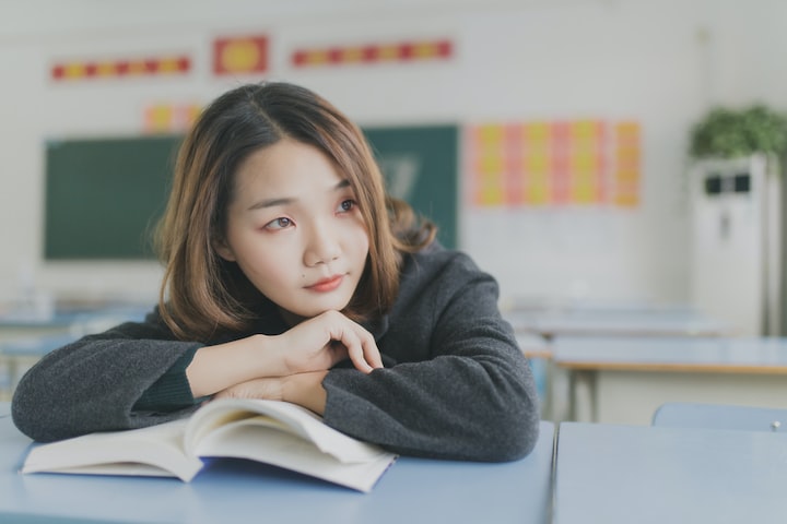 girl sitting and posing on her book